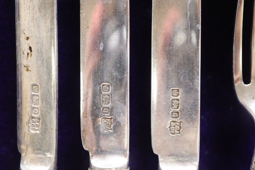 A cased set of twelve mother of pearl handled silver deseert knives and eleven forks, F. Asman & Co, Sheffield, 1908/10,